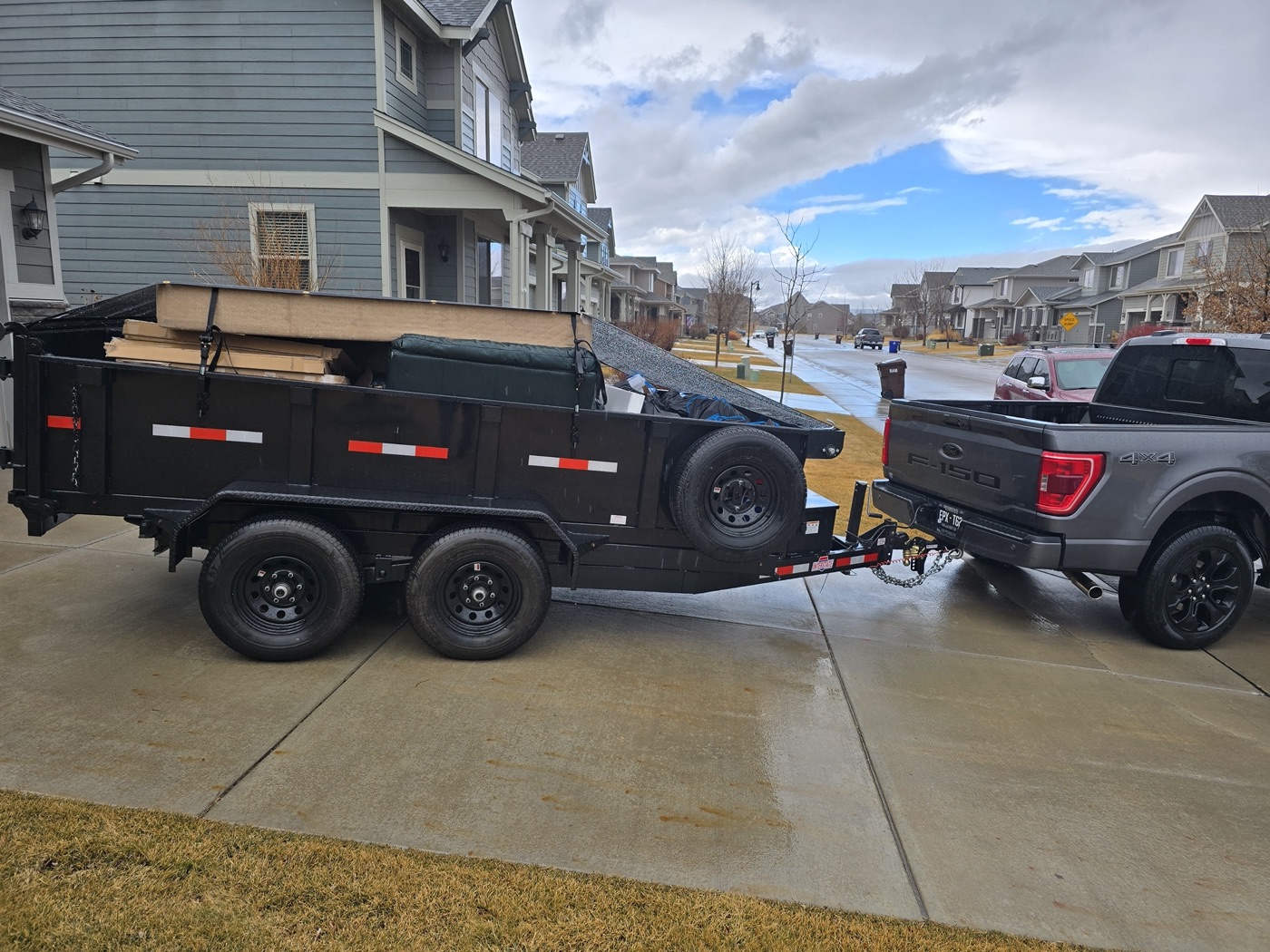 Loaded trailer in neighborhood ready to haul away junk in Northern Colorado