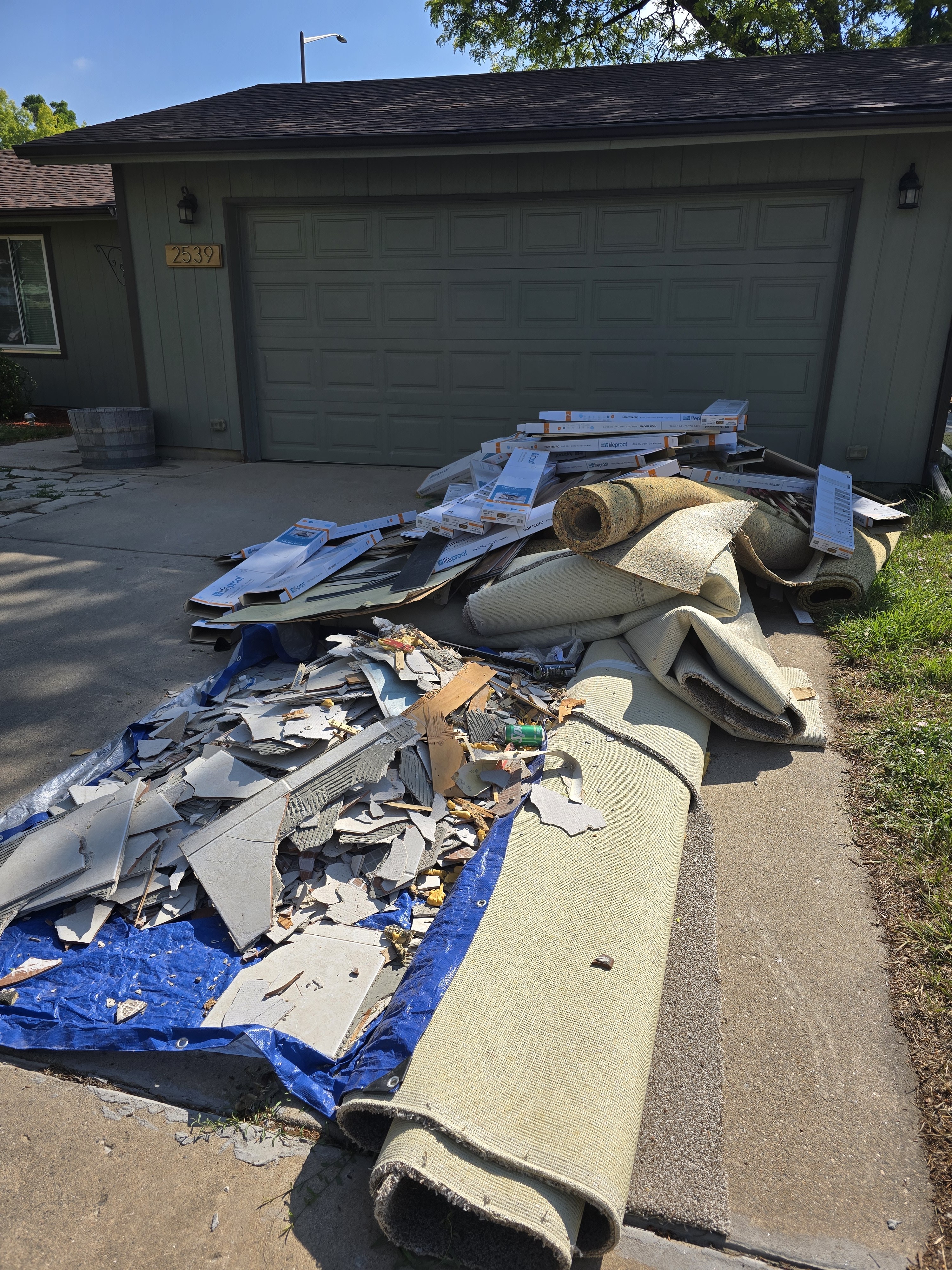 Large pile of construction debris and carpet before junk removal in Northern Colorado