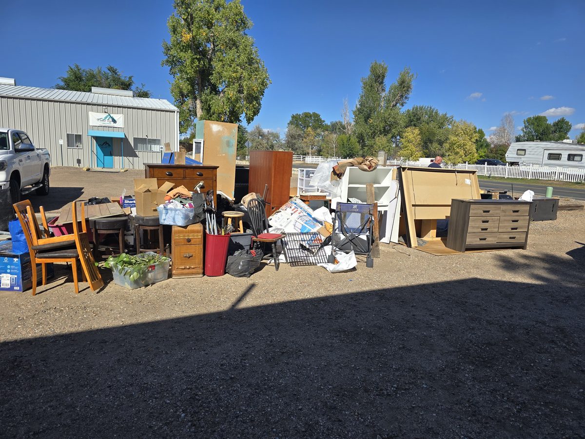 Curbside pile of dressers, chairs, and furniture before junk removal in Northern Colorado