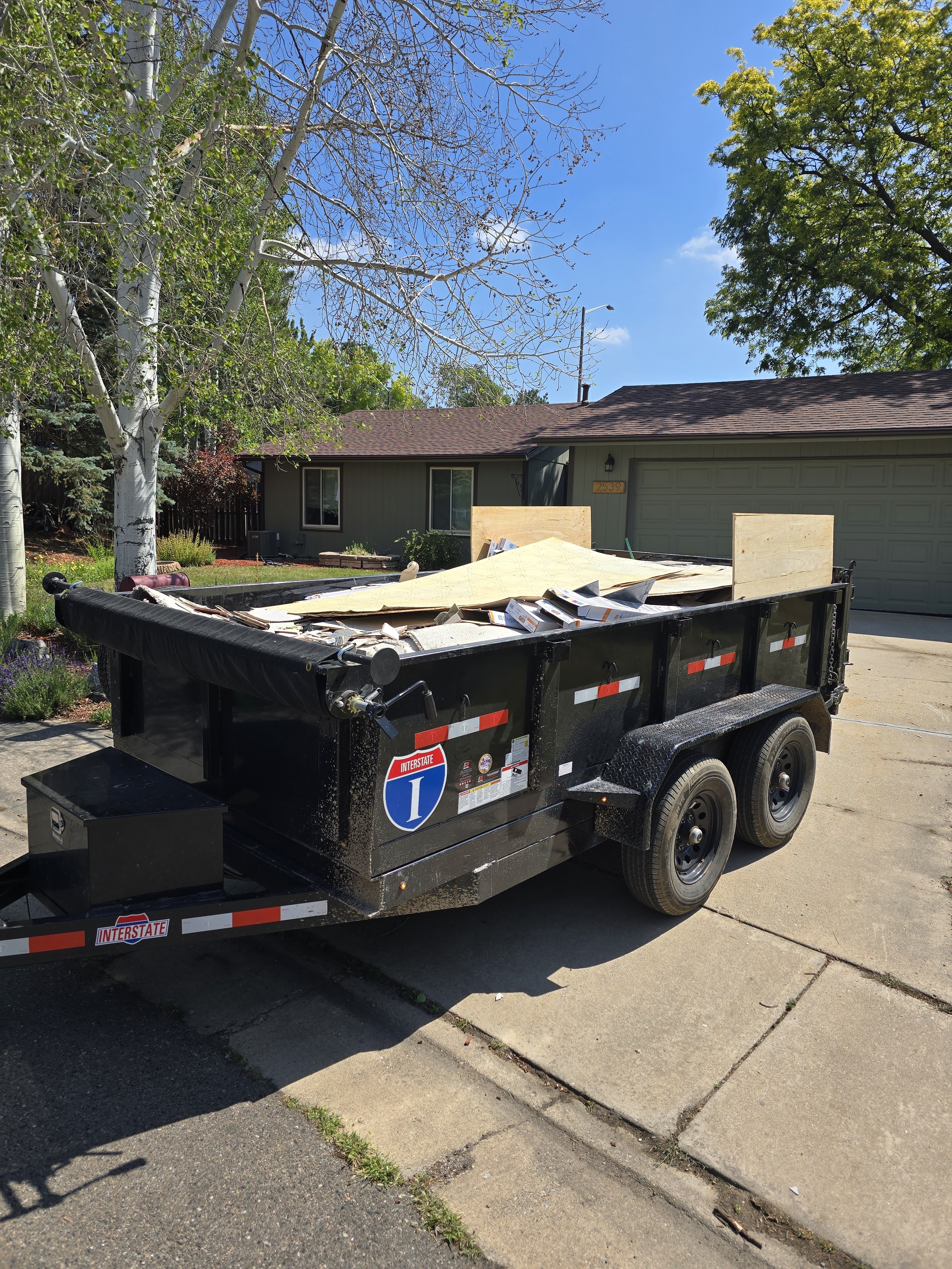 Dump trailer loaded with construction debris after junk removal in Northern Colorado