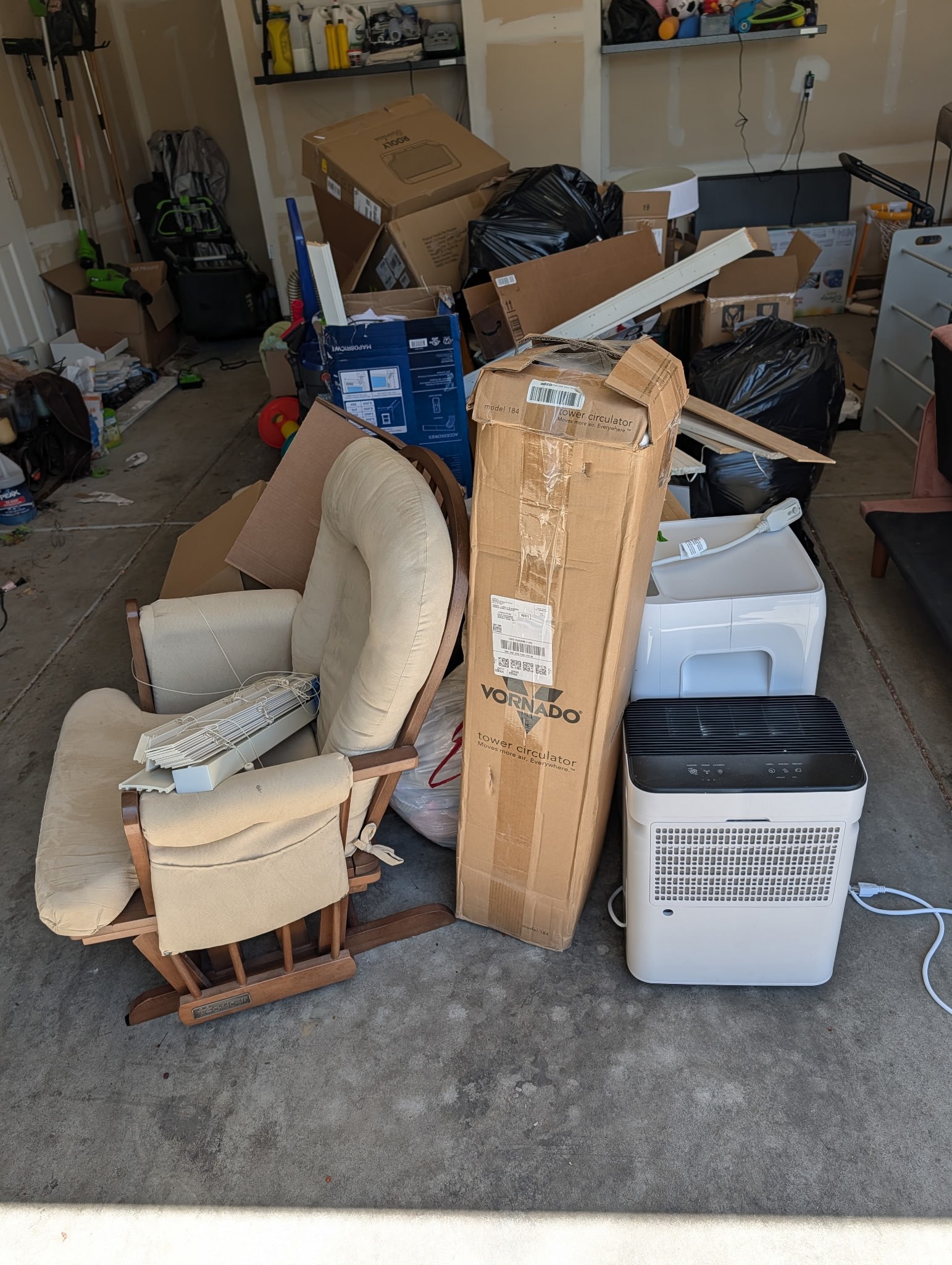 Garage packed with furniture and junk before cleanout in Timnath, CO