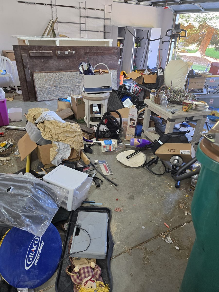 Garage packed with boxes and household items before junk removal in Northern Colorado