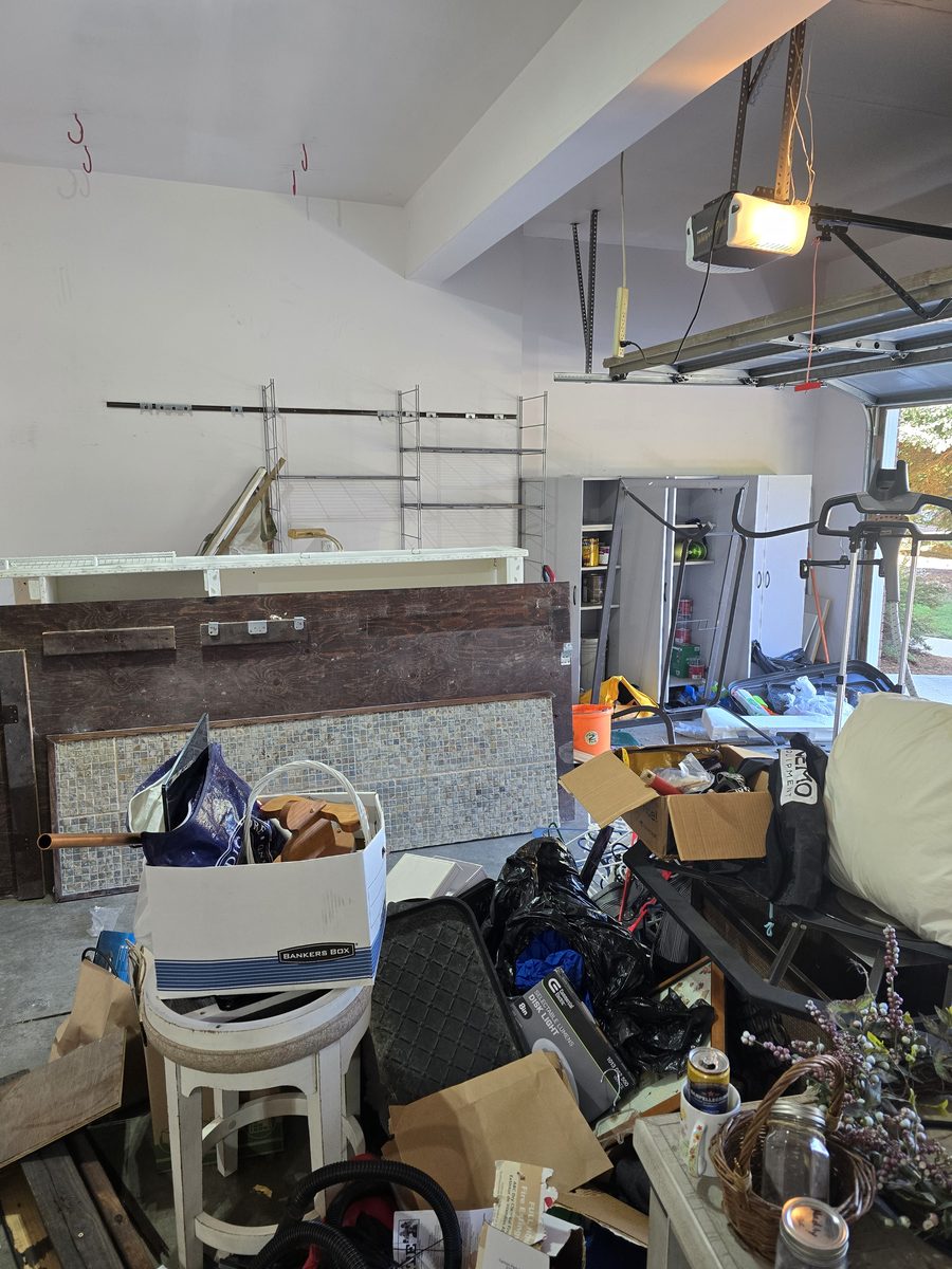 Garage workbench and storage area cluttered before junk removal in Northern Colorado