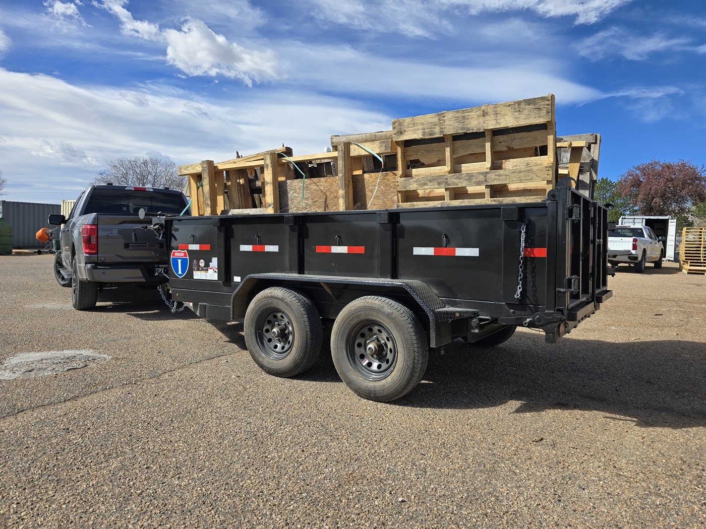 Trailer loaded with construction debris and pallets hauled away