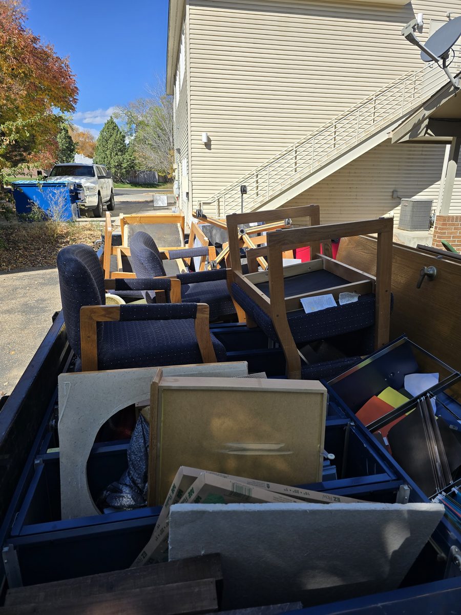 Trailer loaded with office chairs and filing cabinets during a commercial junk removal job in Northern Colorado