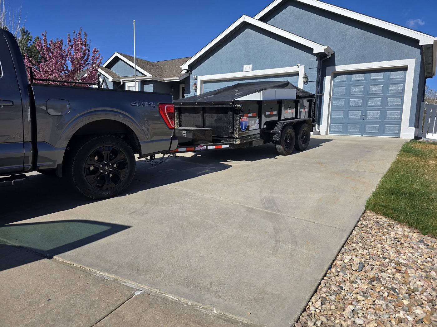 Northern Colorado Junk Removal truck and trailer at a residential job in Northern Colorado